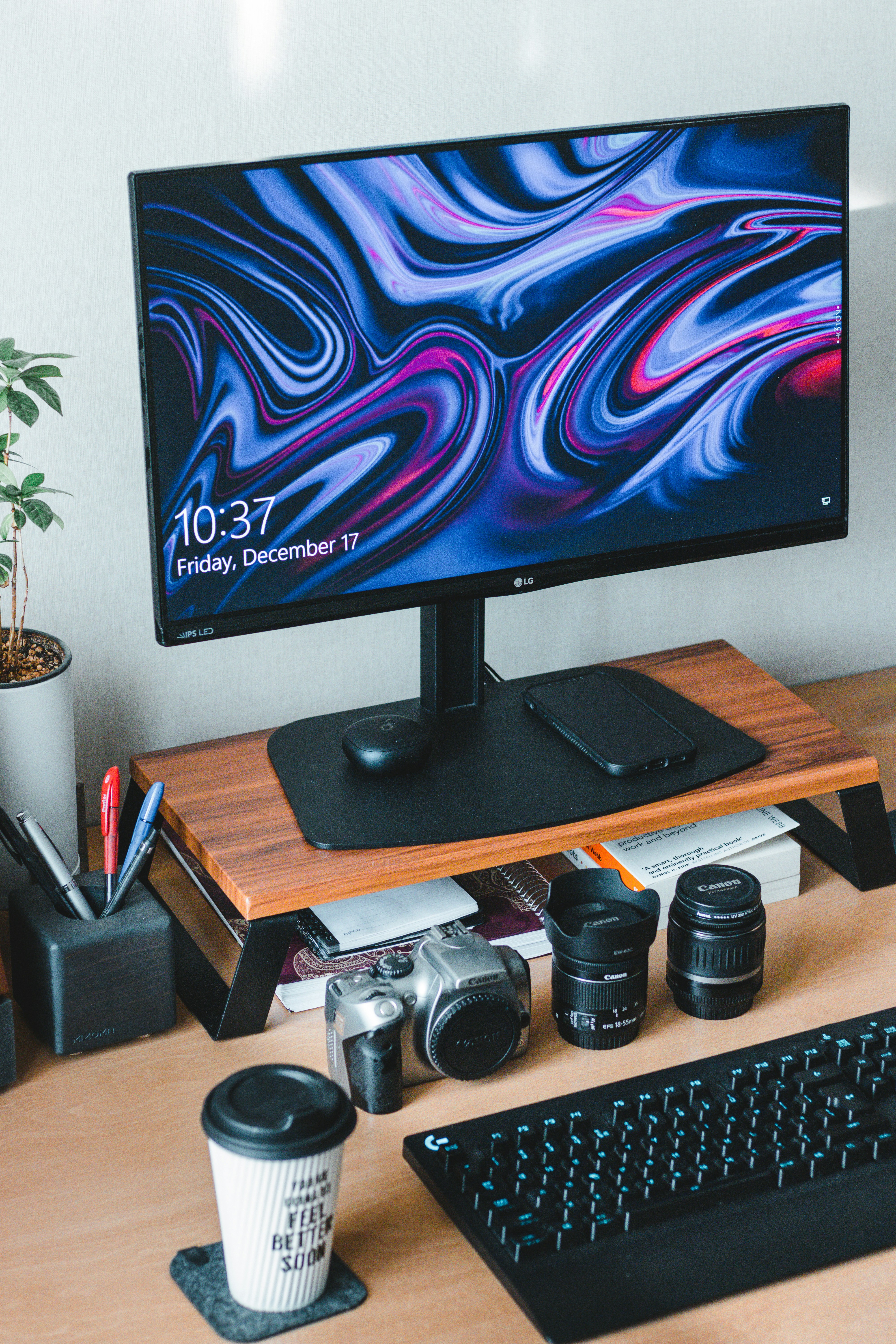Desk with a camera, lenses and a monitor between shoots