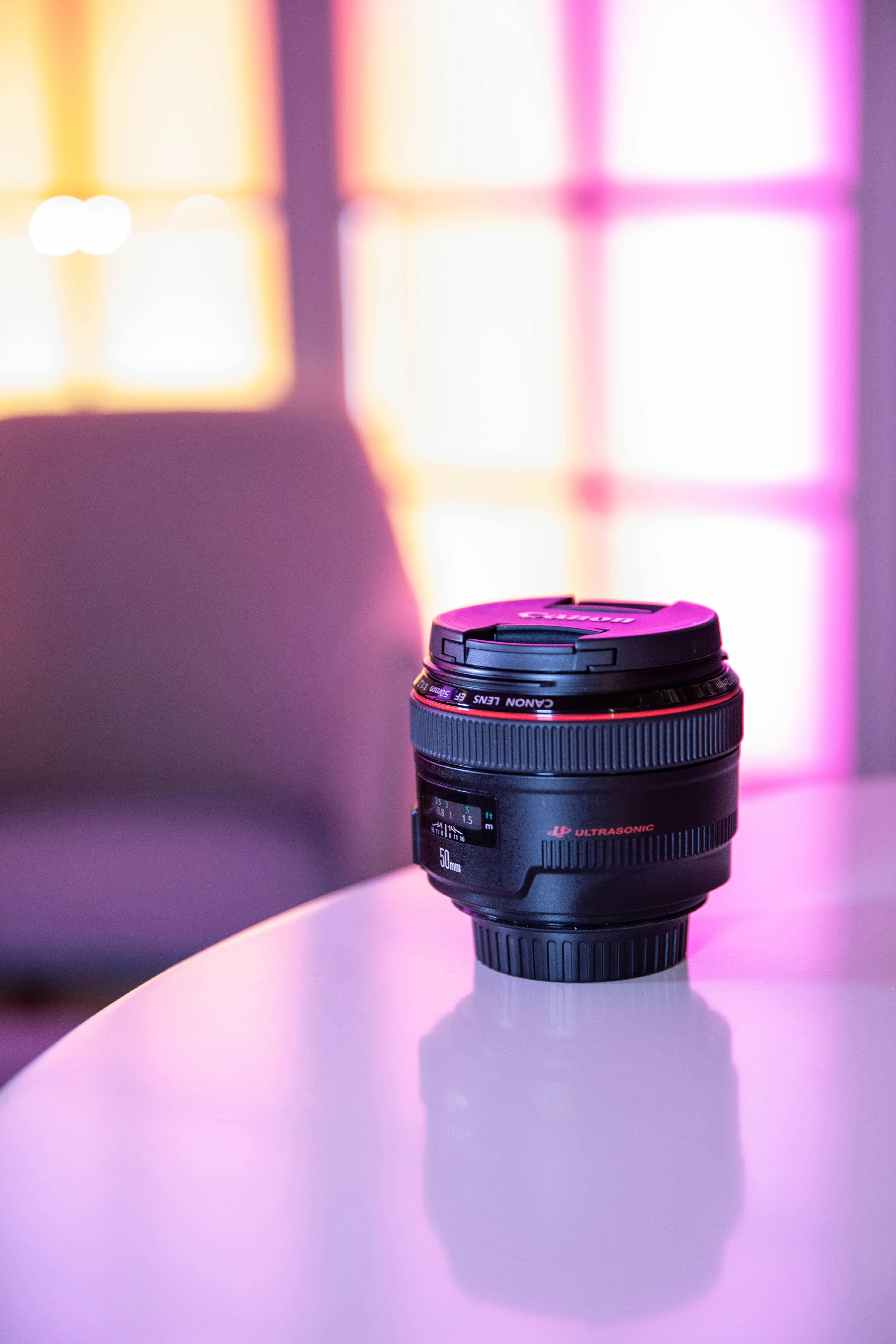 Camera lens standing on a white table