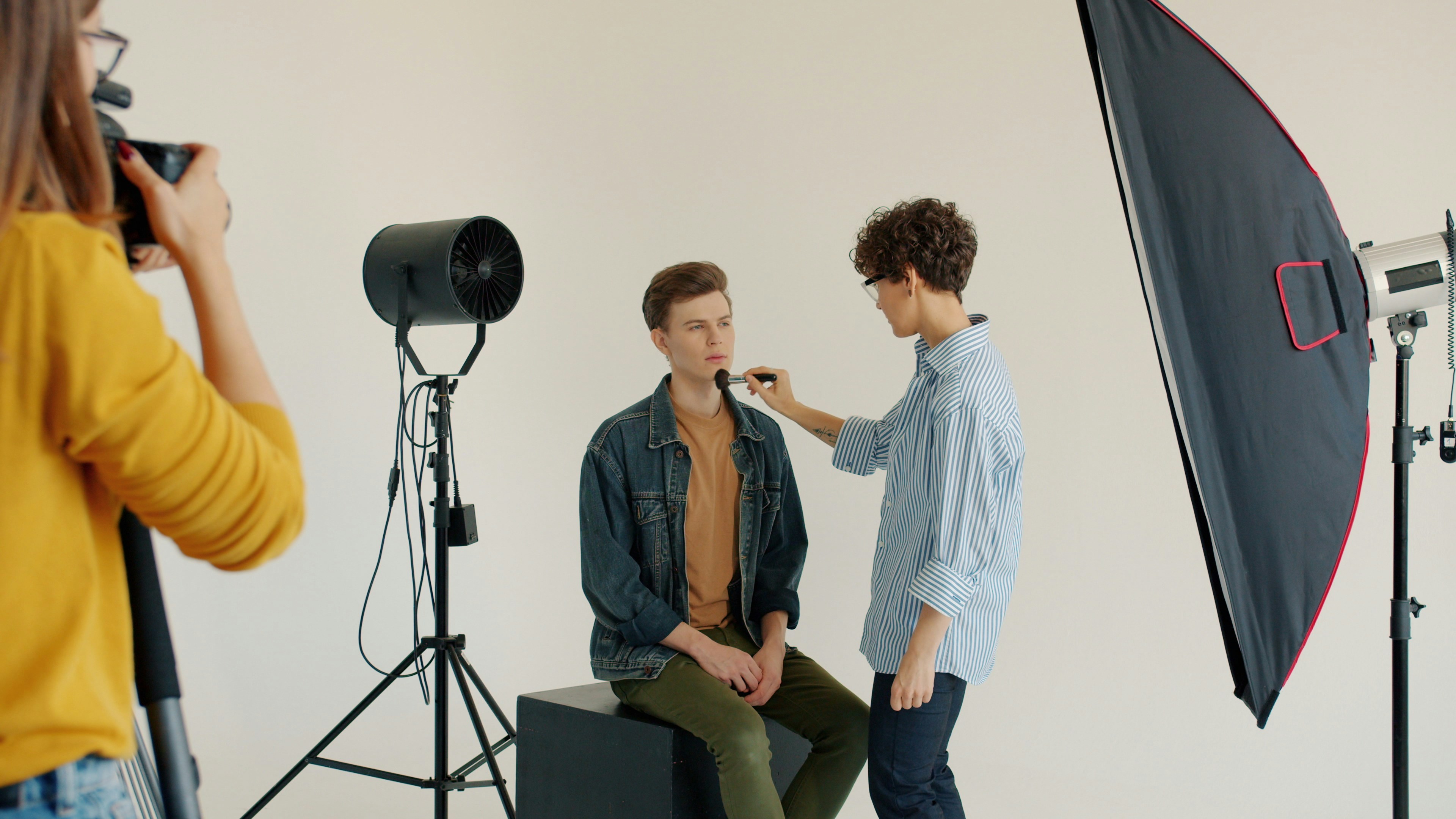 Portrait sitting with a photographer, a stylist and studio lights